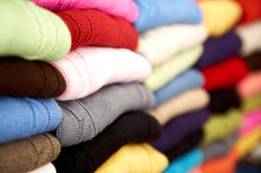 colourful clothes stacked in a retail store - woolen jumpers